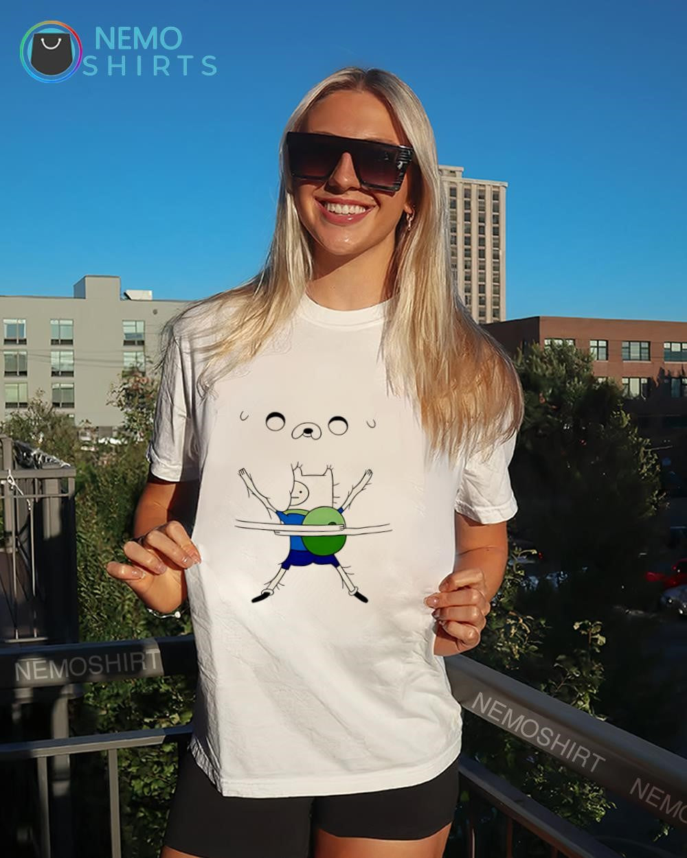 Finn holding Jake Adventure Time shirt